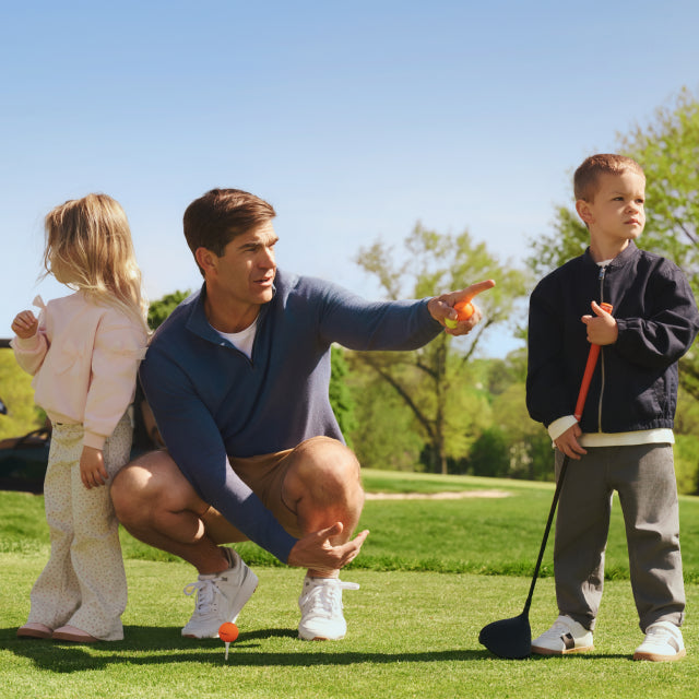 Shane Bacon golf broadcaster posing with his kids while wearing Mack Weldon