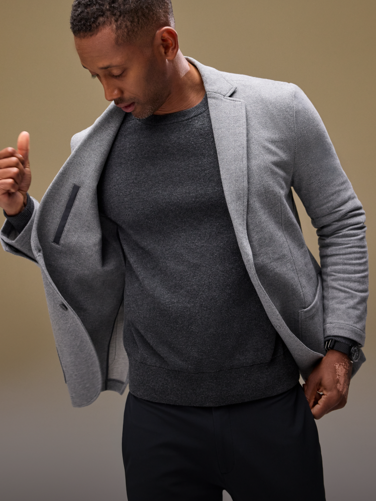 Guy holding open his ACE Blazer to show inside pocket