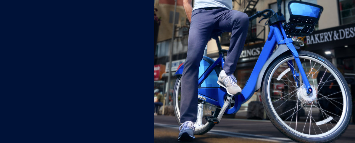Man riding a bike wearing Broken Twill 5 pocket pant 
