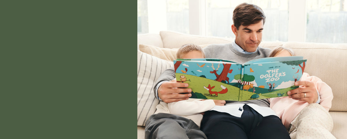 Man with his children reading the Golfer's zoo book