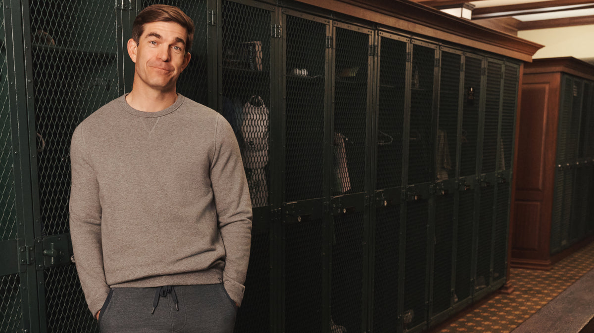 Man in the locker area wearing ACE Crew Neck Sweatshirt