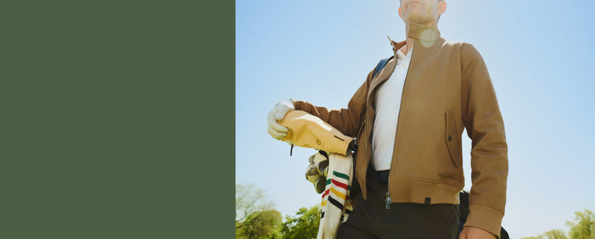 Man wearing Harrington Jacket while playing golf.
