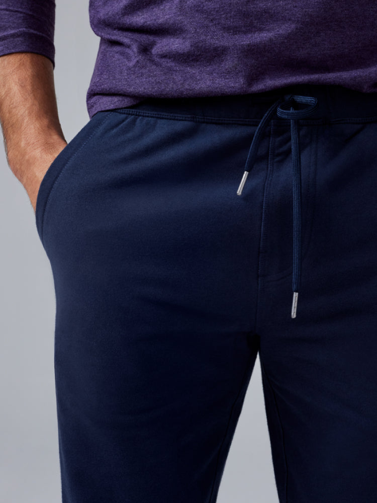 close up image of a man's waist wearing a navy blue sweatpant