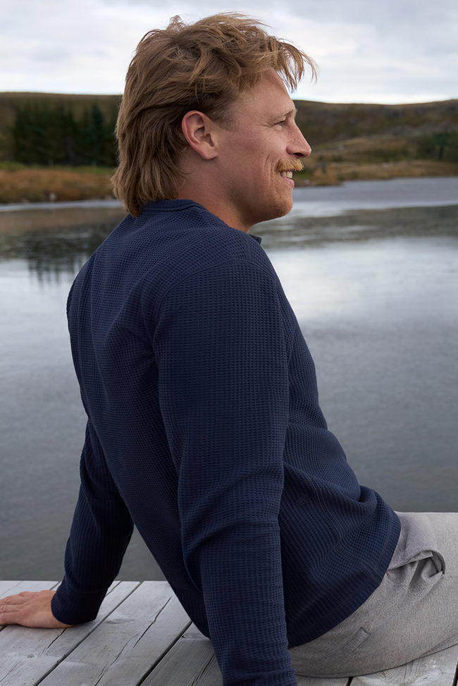 Man wearing WARMKNIT Waffle Long Sleeve Henley in Total Eclipse