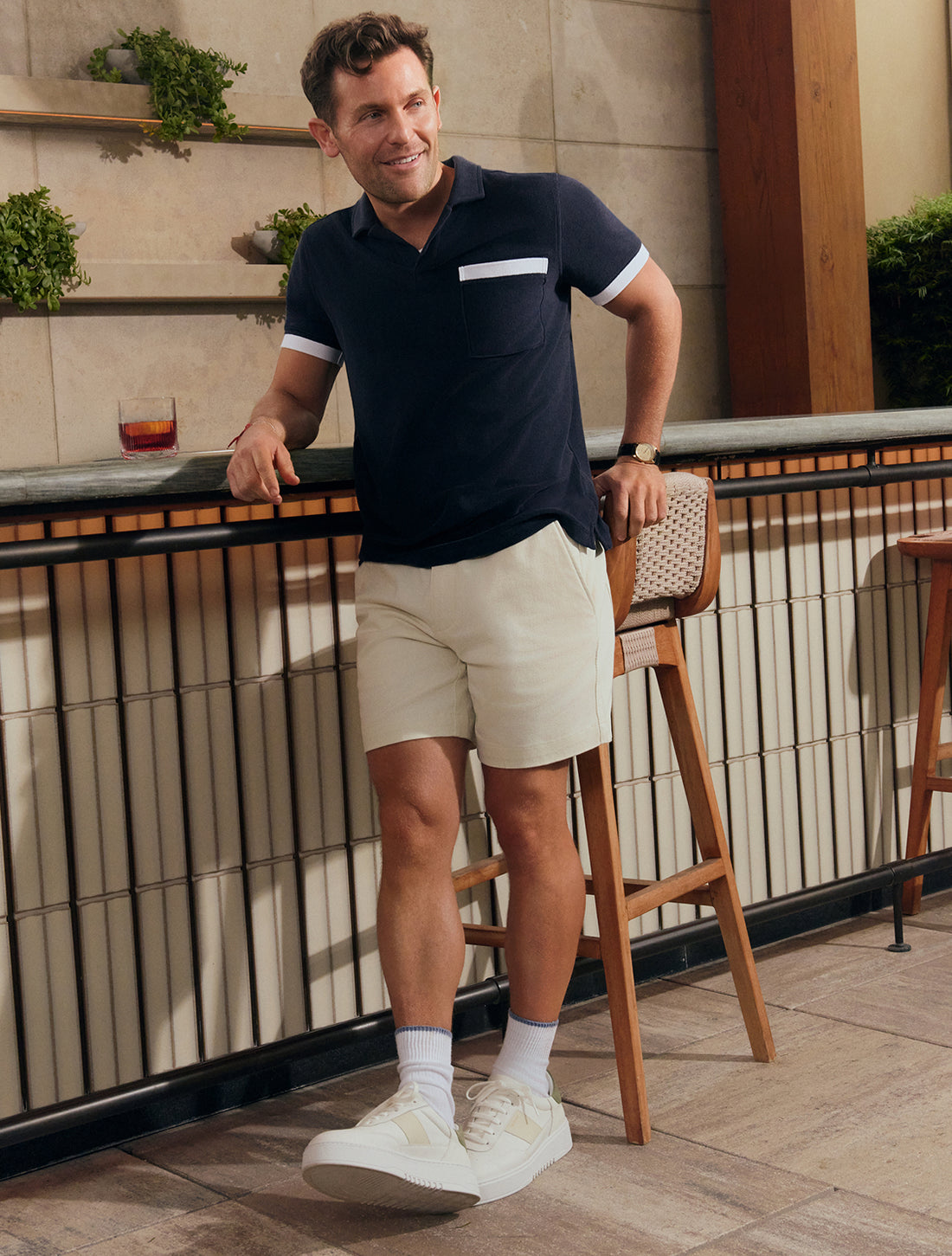 Man wearing Terry Cloth Johnny Collar Polo and Stretch Twill Chino Drawstring Shorts