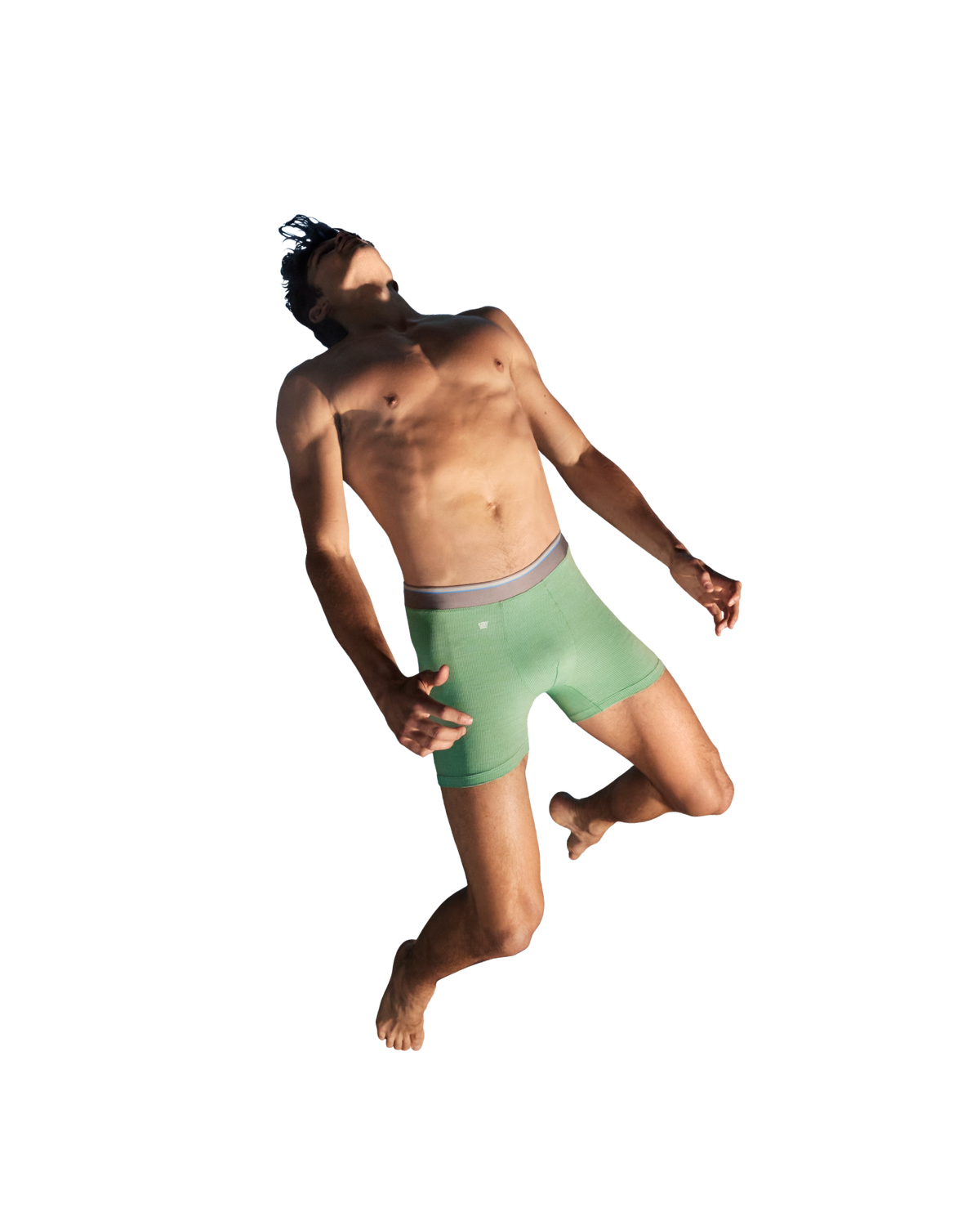 Image of a man jumping in the air wearing green boxer briefs