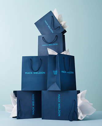 Piled Mack Weldon shopping bags